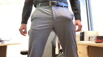 Bulging in gray slacks at work