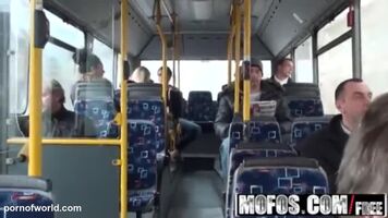 The couple has sex on the bus. Passengers are nearby